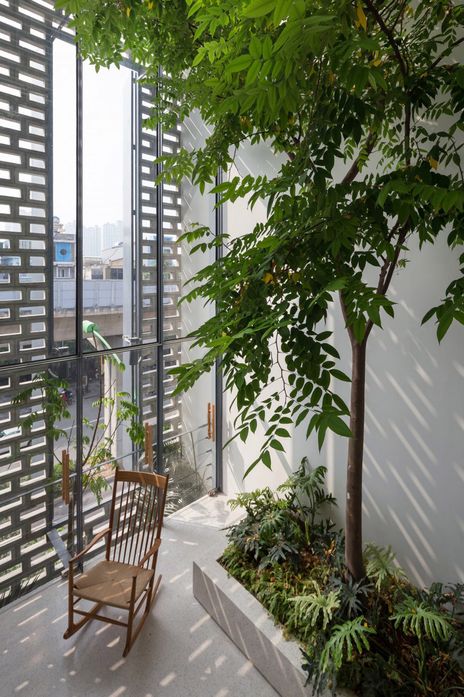 Facade window and trees at CH House by ODDO Architects