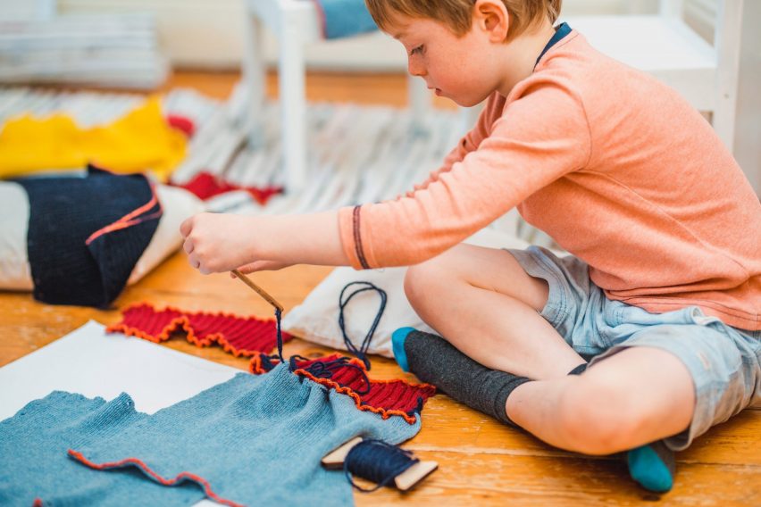 Young child making clothes