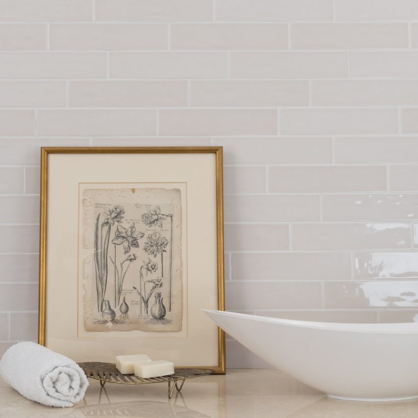 Habitat tiles in the alabaster glossy finish on a wall with a photo frame
