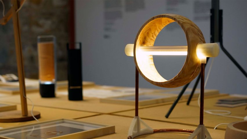 Circular gold table lamp on a desk