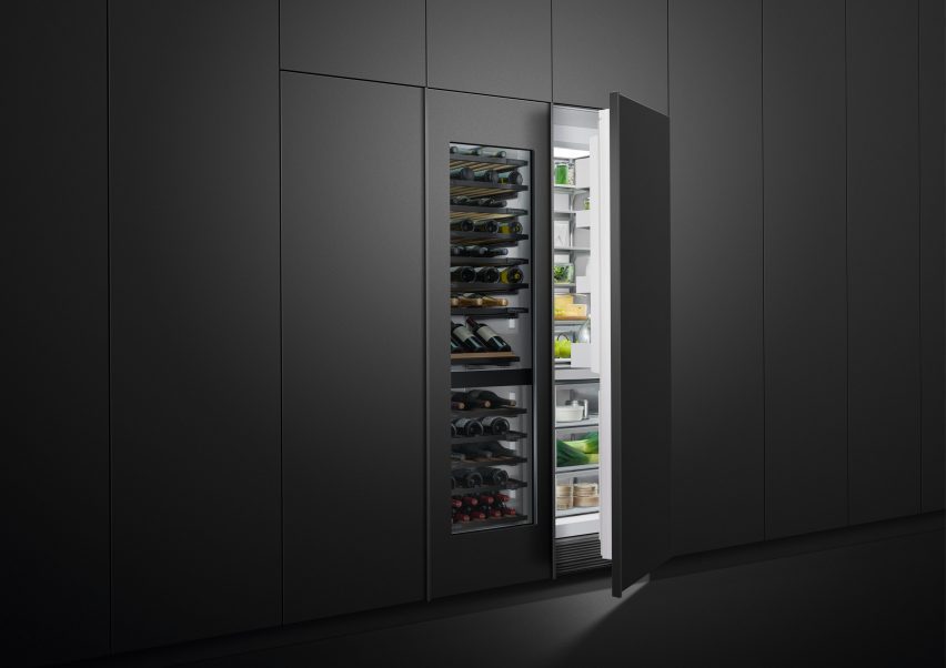 Fridge and wine chiller partially concealed inside a wall of in-set charcoal-toned cabinets
