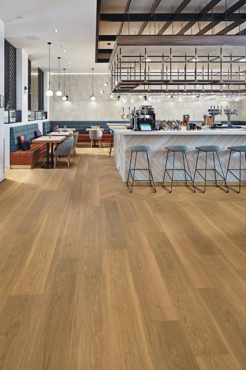 Warm plank flooring from the Van Gogh Multi-format collection covers the bar floor
