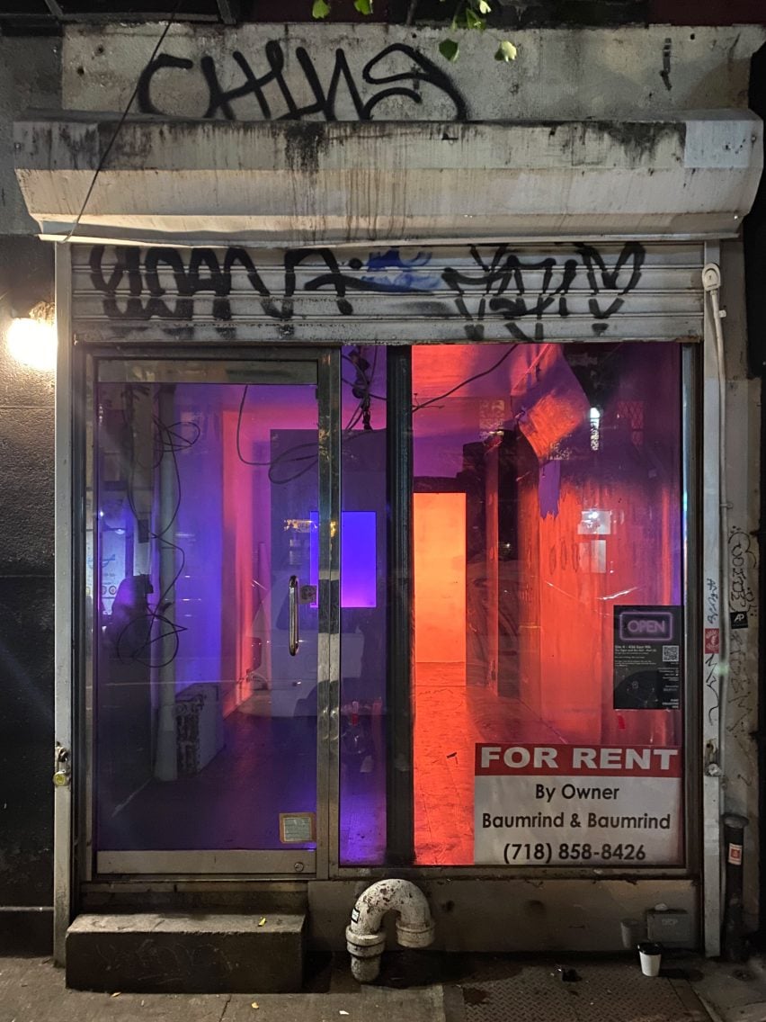 A storefront with graffiti and a light installation