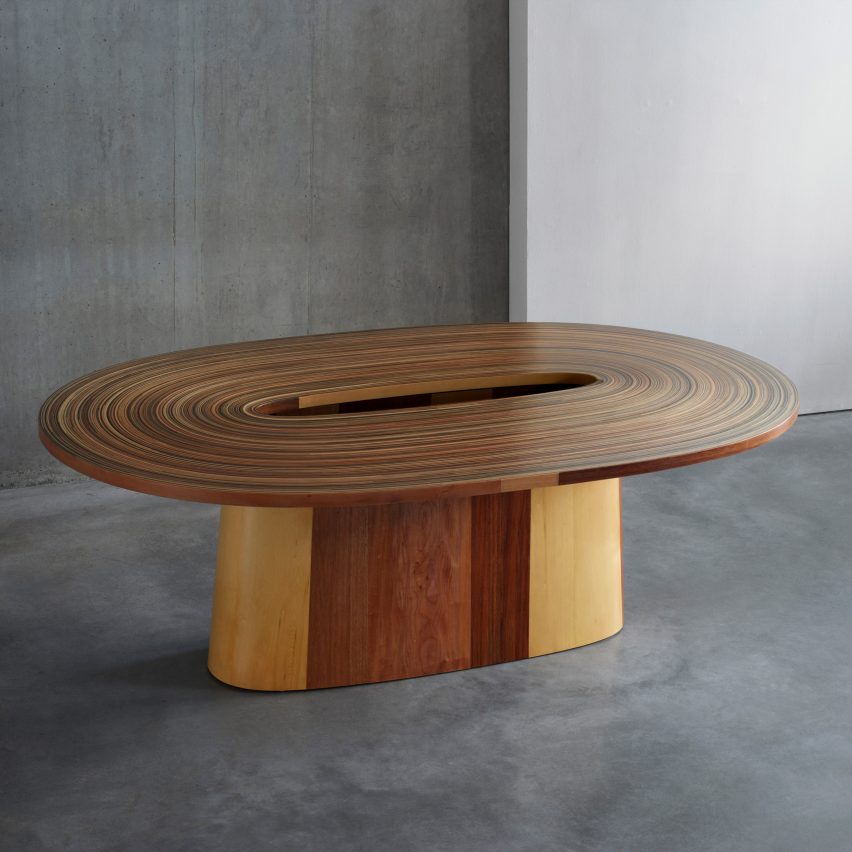 A brown oval shaped table by Brodie Neill