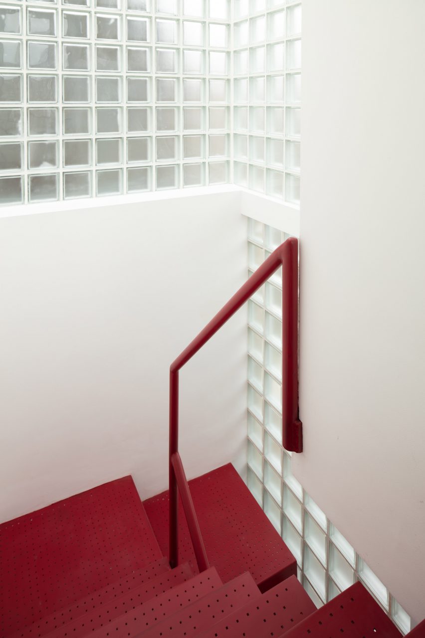 Red staircase with glass brick walls in Maryland House by Remi Connolly-Taylor 