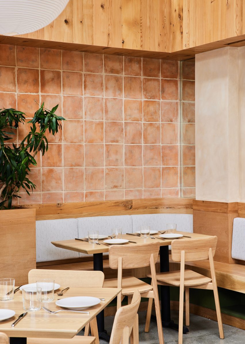 Dining tables and terracotta tiled wall