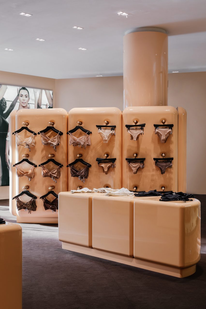 Underwear displayed on hangers and on counters in the SKIMS store