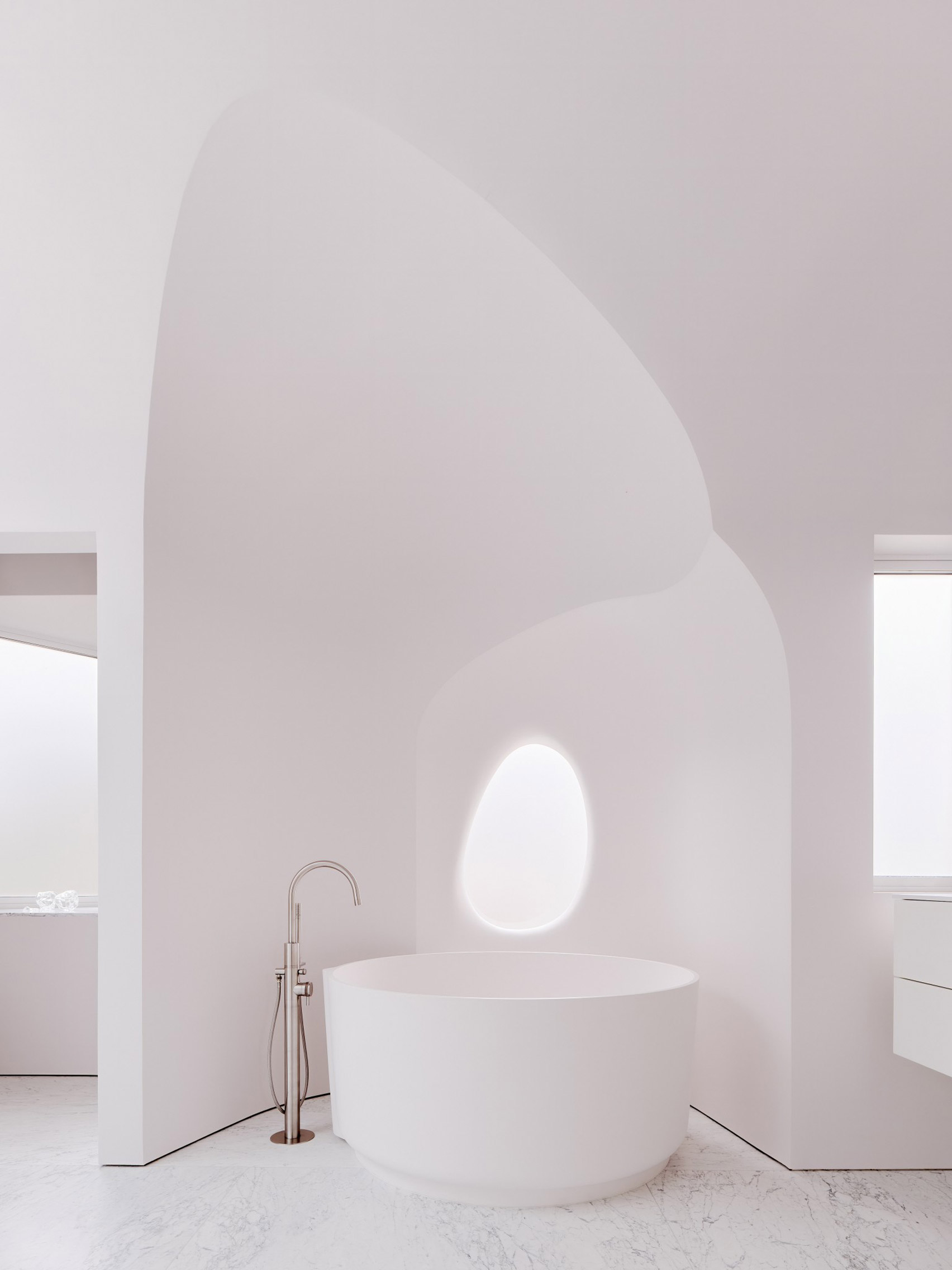 Freestanding white tub in bathroom nook designed by OPA