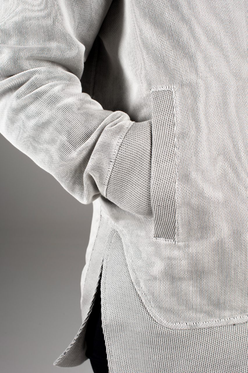 Close-up on light-grey jacket with integrated solar panels completely concealed under the fabric