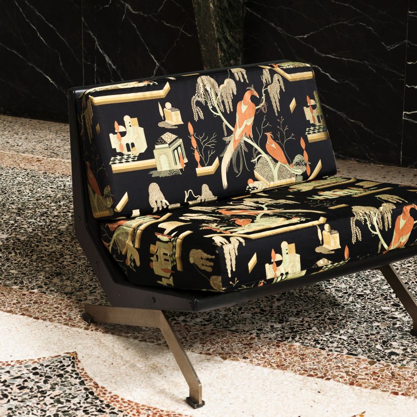Two-seater black sofa upholstered in Dedar's This Must Be The Place fabric with golden embroidered birds and plants