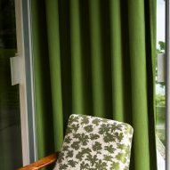 Dedar's Be Bop A Lula fabric with green palm trees being used on an armchair