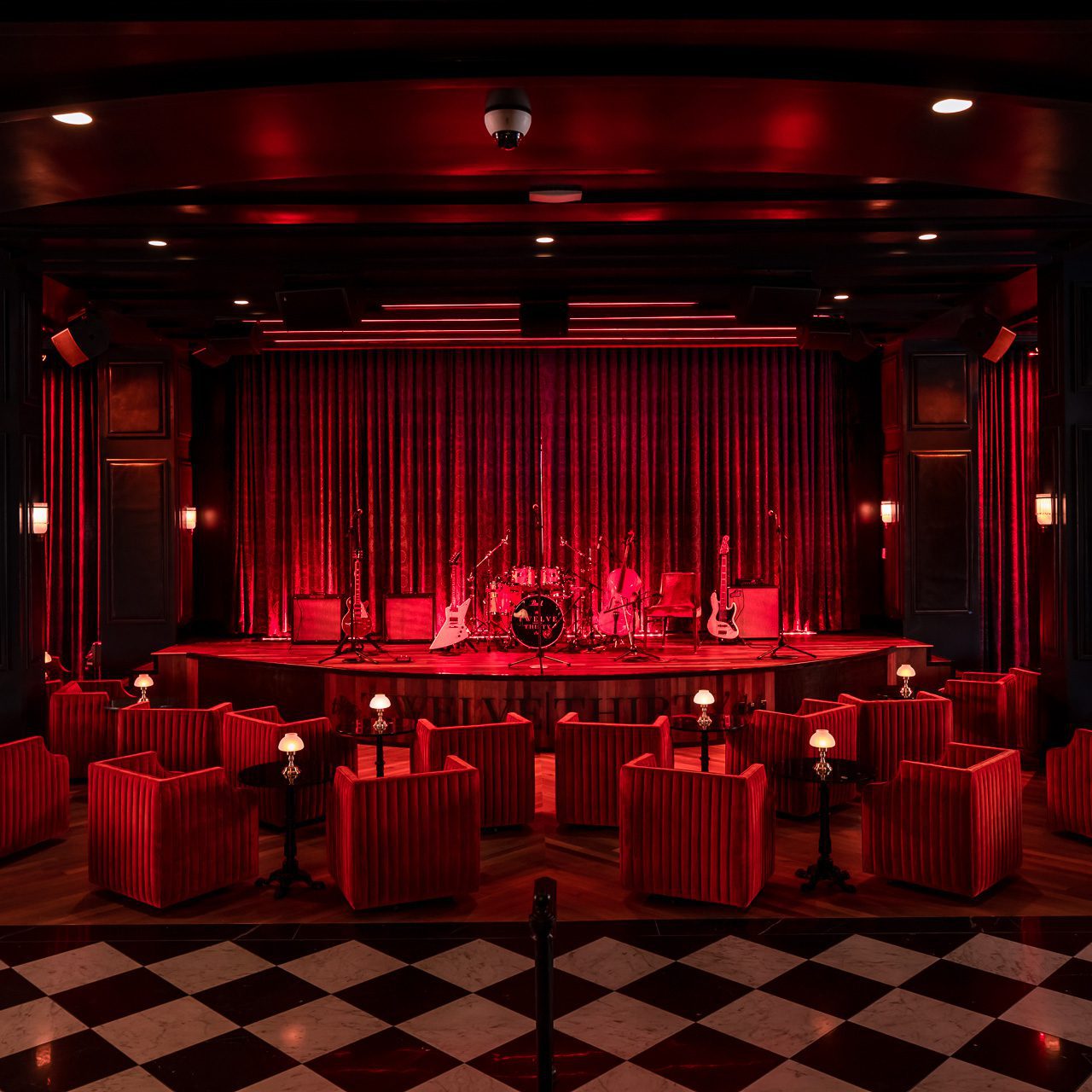 A dark room with red lighting and furniture 