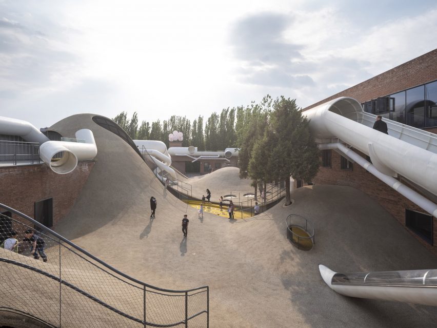 Undulating floors engulf buildings at the playscape childrens community centre