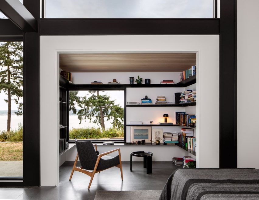 Reading nook with white walls and black shelving