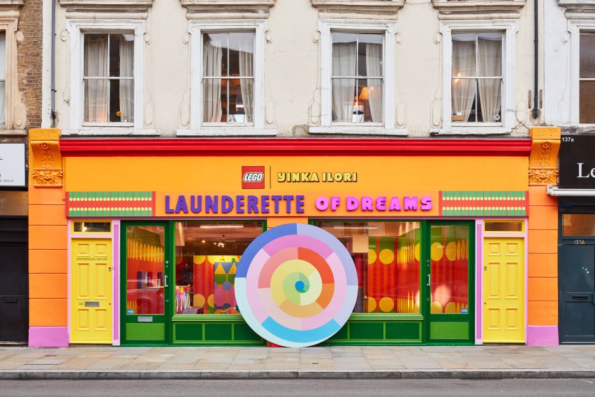 Exterior of a colourful shopfront on Bethnal Green Road with a sign reading Laundrette of Dreams