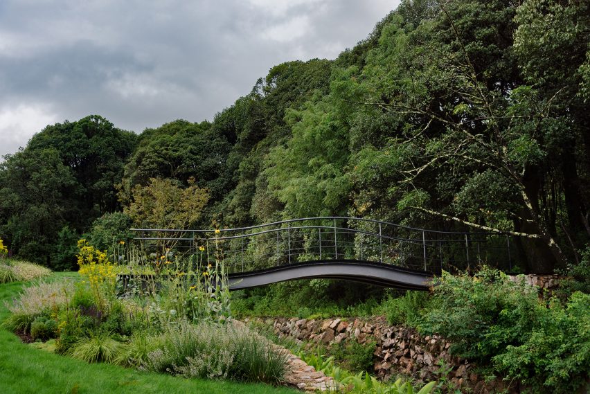A bridge crosses a small channel at alpine garden