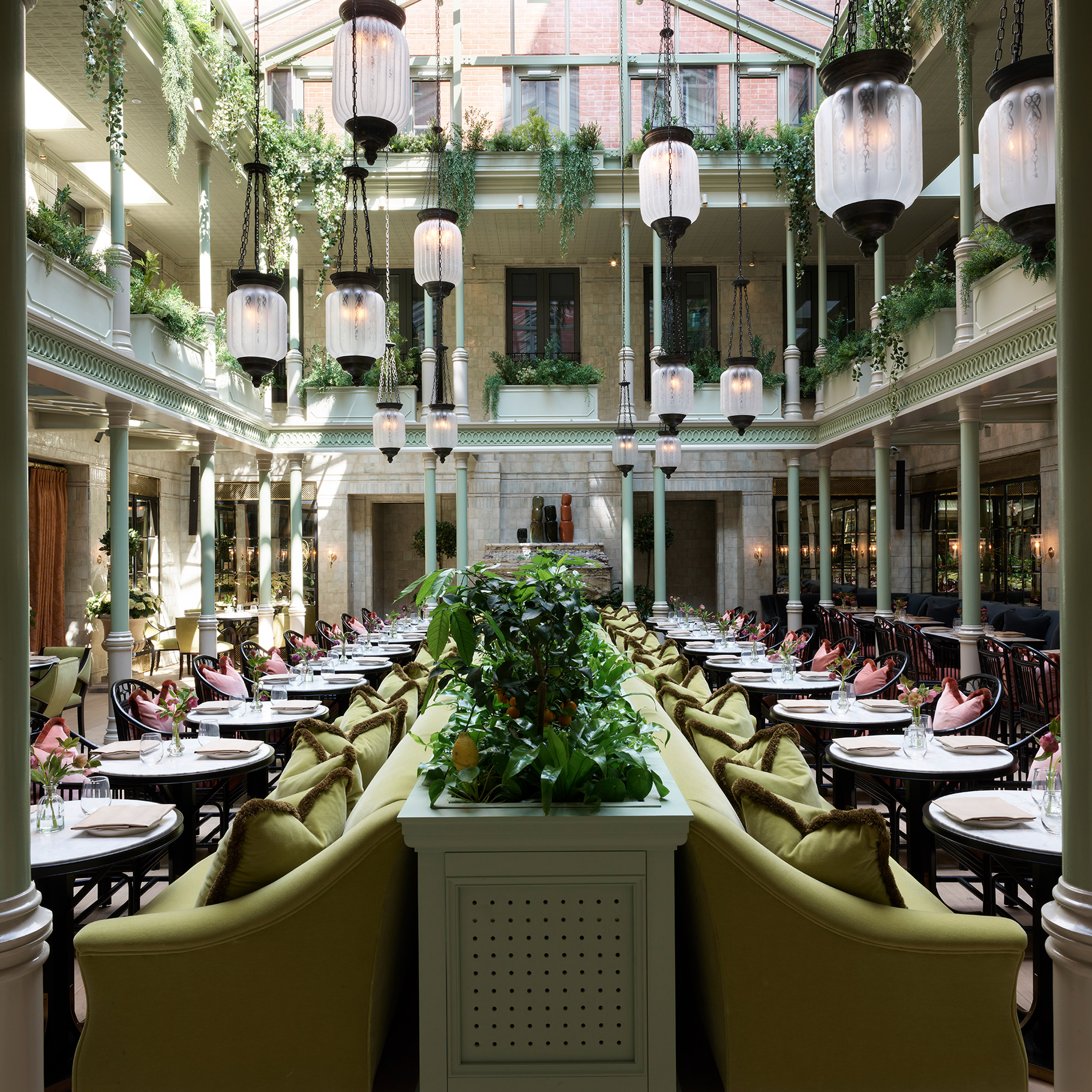 A photograph of the NoMad hotel's restaurant with lanterns and plants