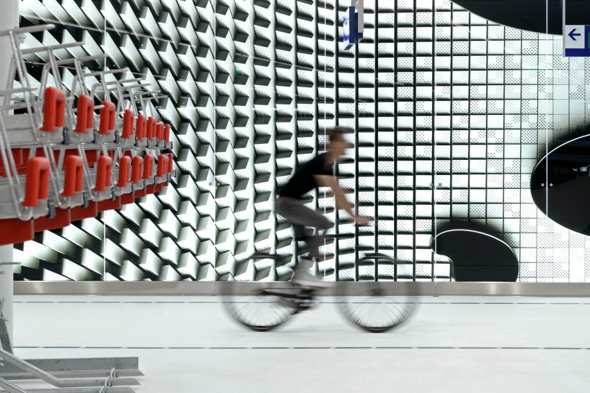 A man cycling through Bicycle Garage the Hague