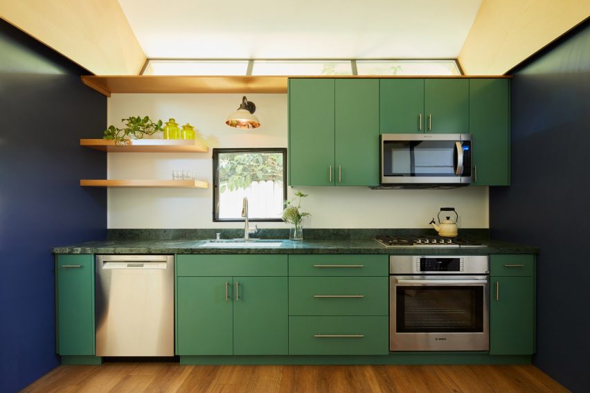 Green kitchen with triangular rafters