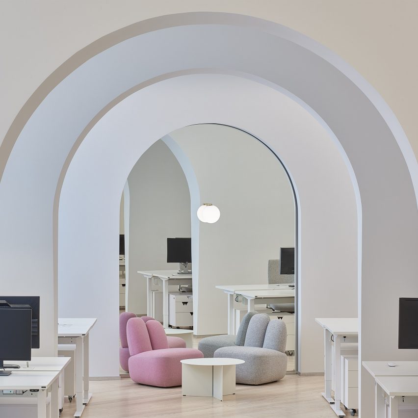 A photograph of two Bunny chairs in pink and grey in an office environment