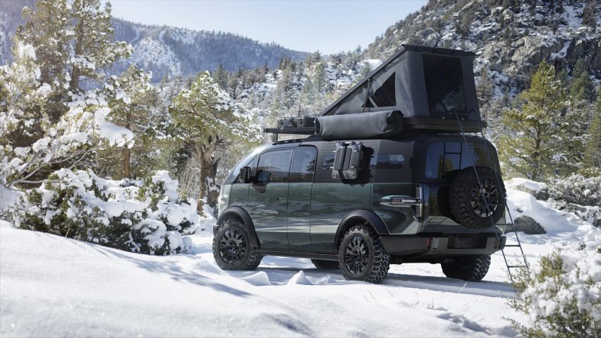 Canoo Pickup truck with mobile home attachment on the back driving on snowy mountains