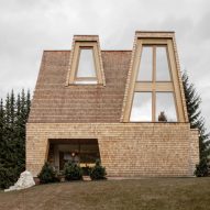 Shingles made from salvaged larch wood cover Alpine house in Italy