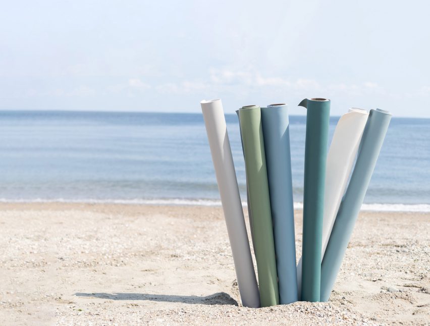 Rolls Ultrafabrics' Coast fabrics in shades of blue, green and white perched up on a beach