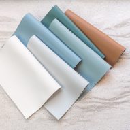 Sheets of Ultrafabrics' Coast fabrics in sandy brown, teal, light blues and white