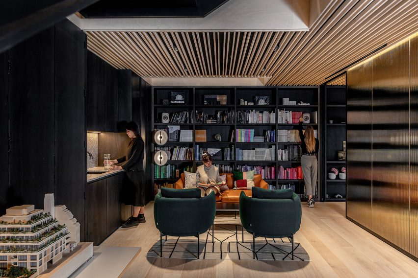 An office breakout space with armchairs and a bookcase