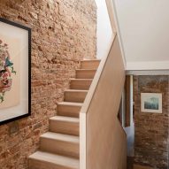Wooden staircase and exposed brick wall