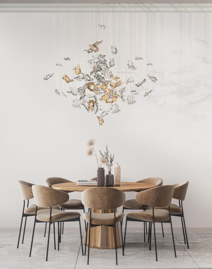 Lasvit's Dancing Leaves glass lighting sculpture in light amber and clear hanging above a residential dining table