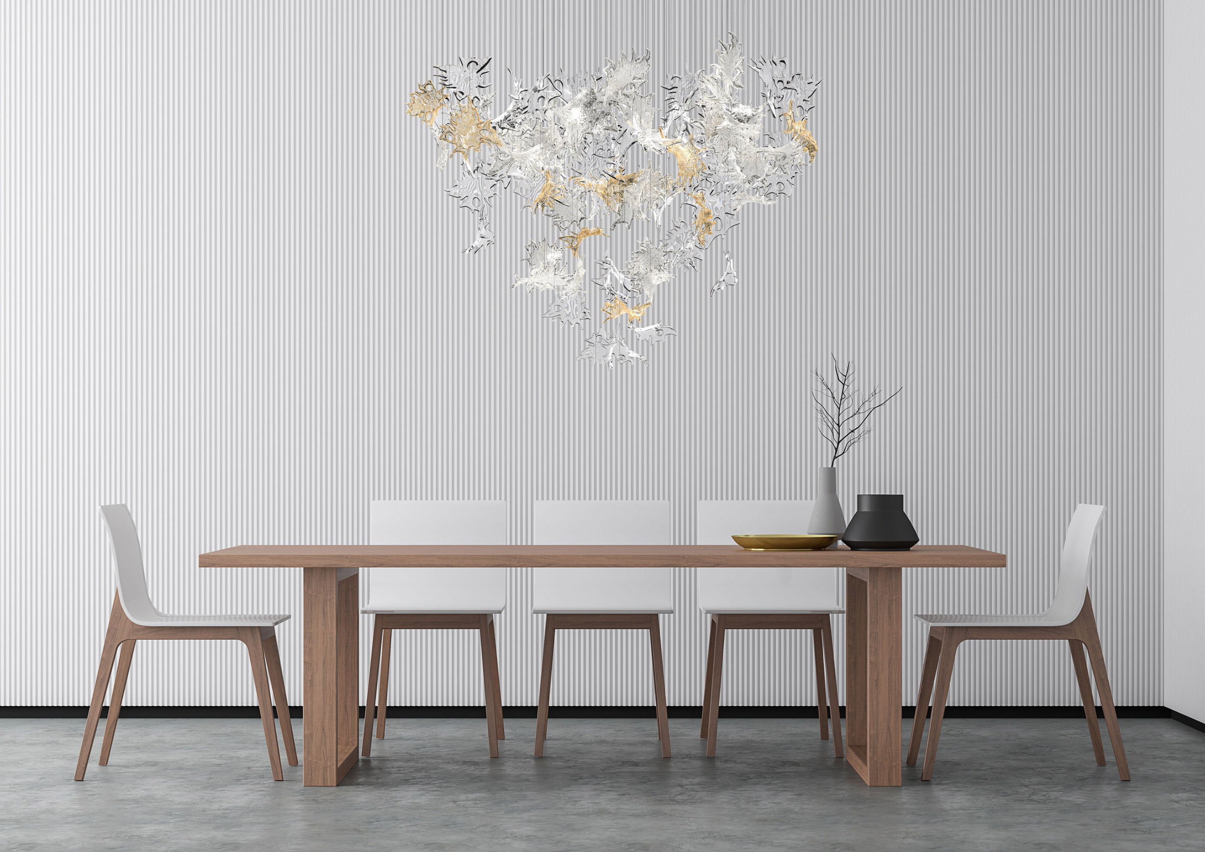 Lasvit's Dancing Leaves glass lighting sculpture in light amber and clear suspended above a dining table