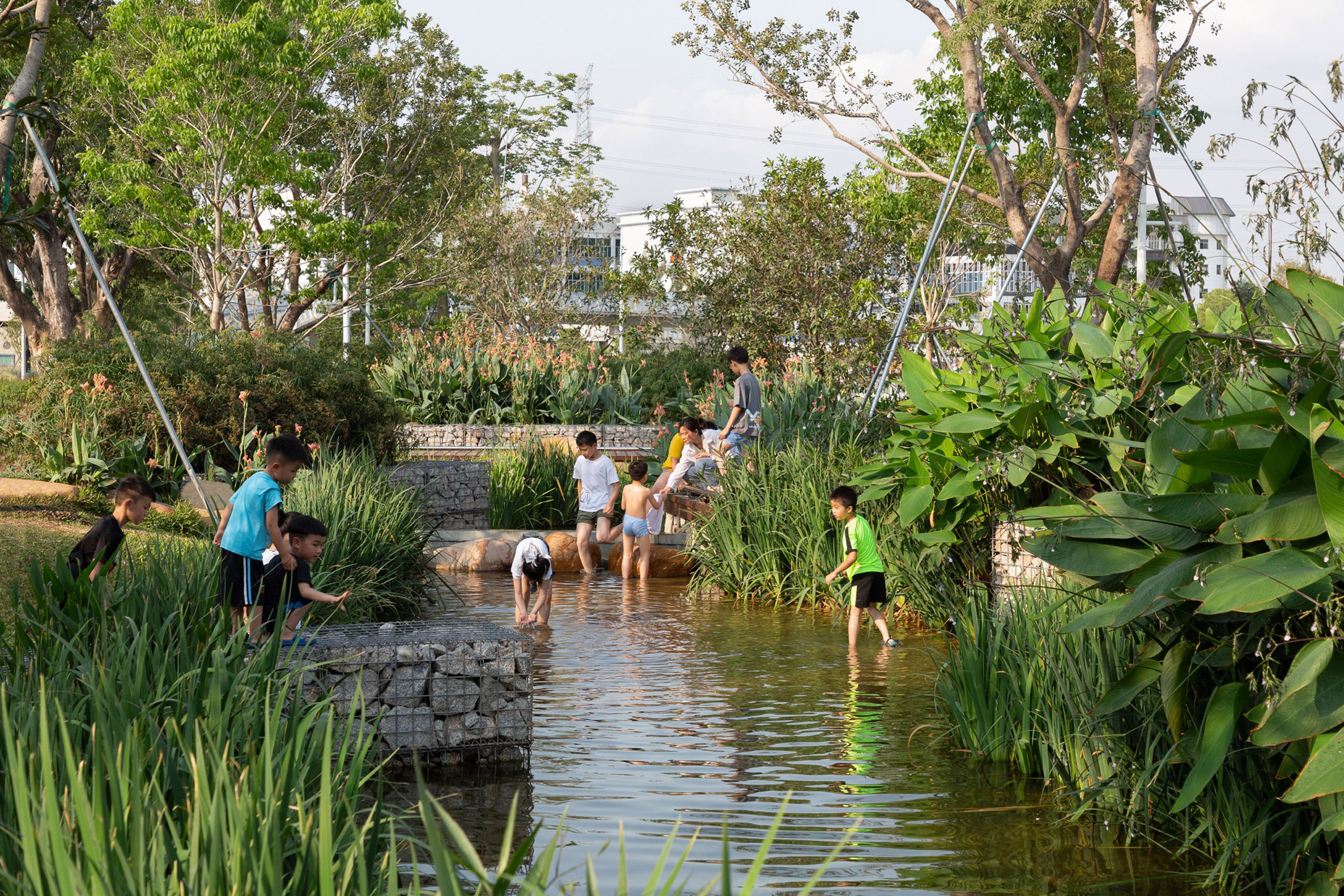 Children are pictured playing in streams at Haoxiang Lake Park