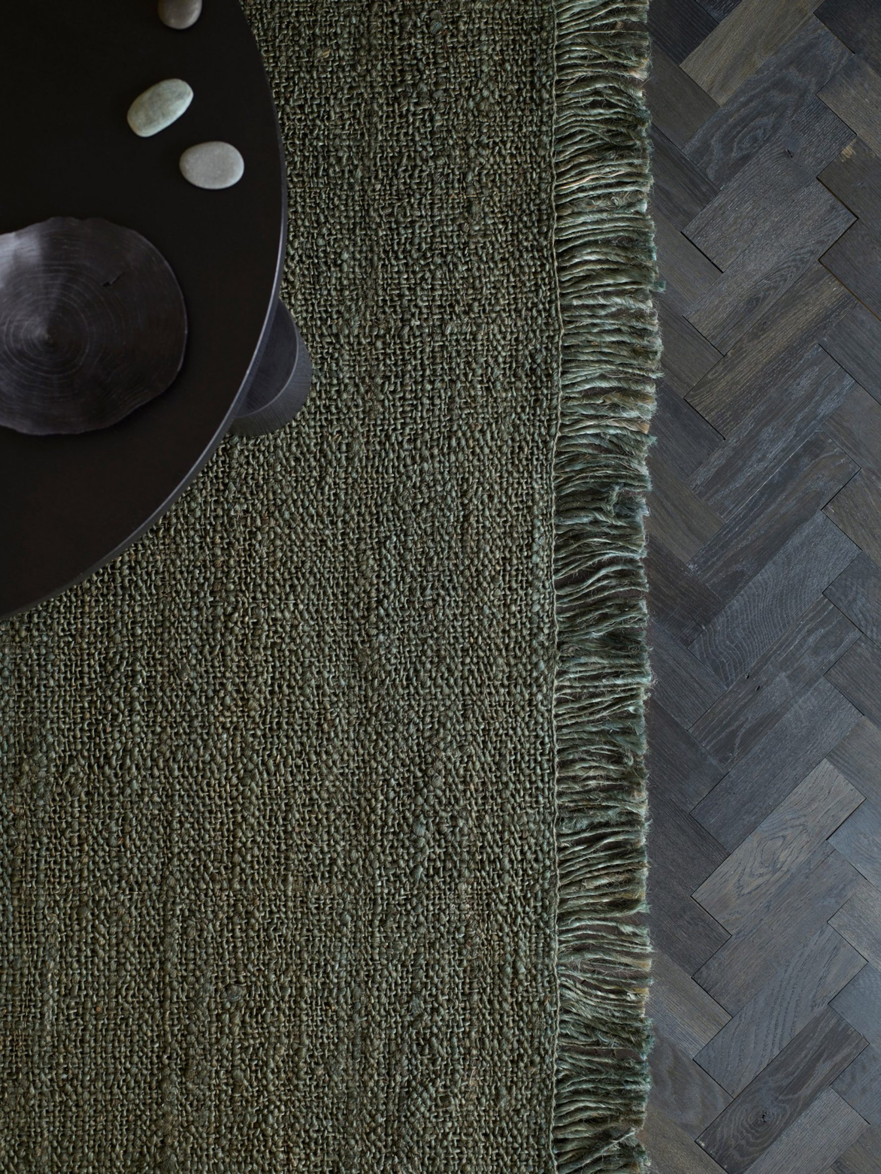 A green rug from the Ellipse Collection