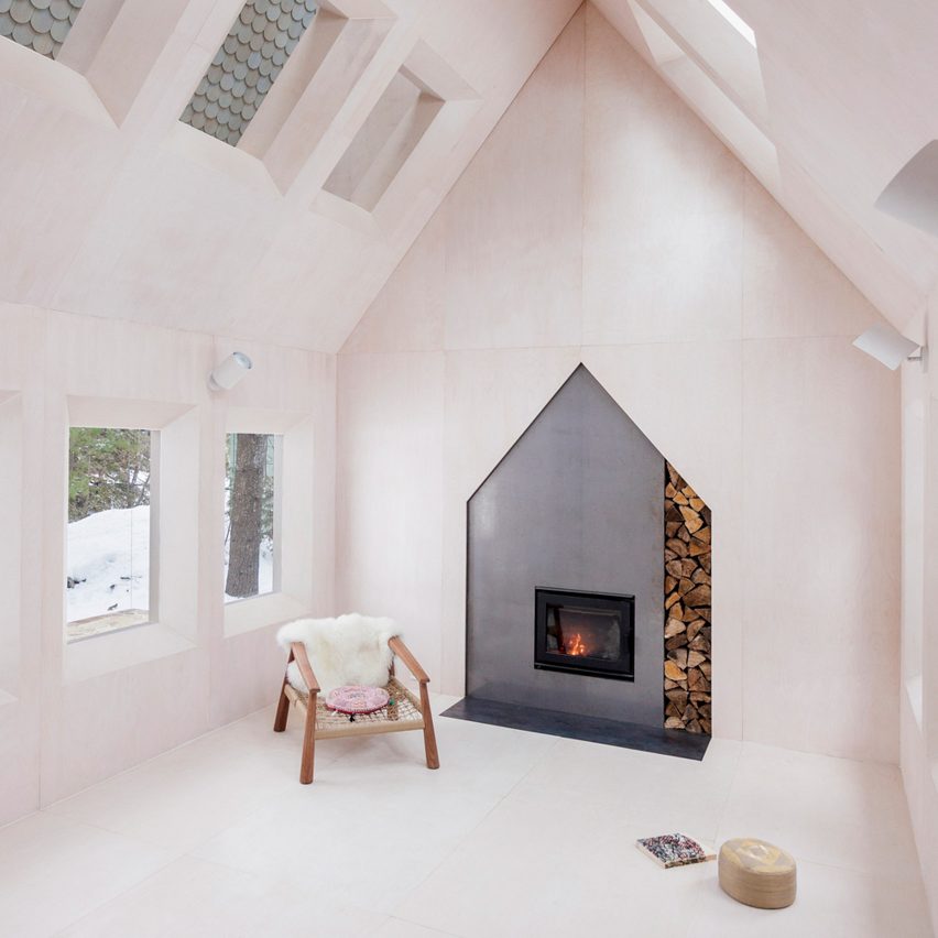 A fireplace in a wood-clad home