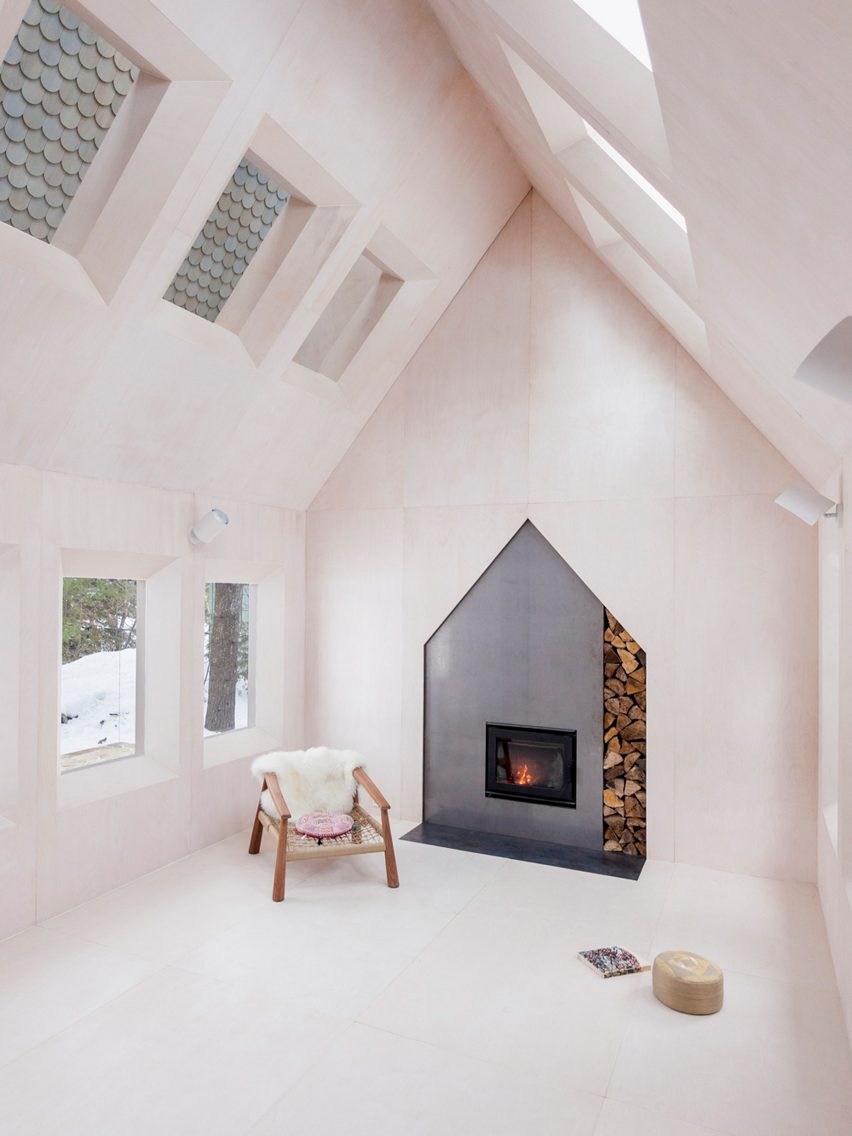 A gable shaped fireplace was built into wooden walls