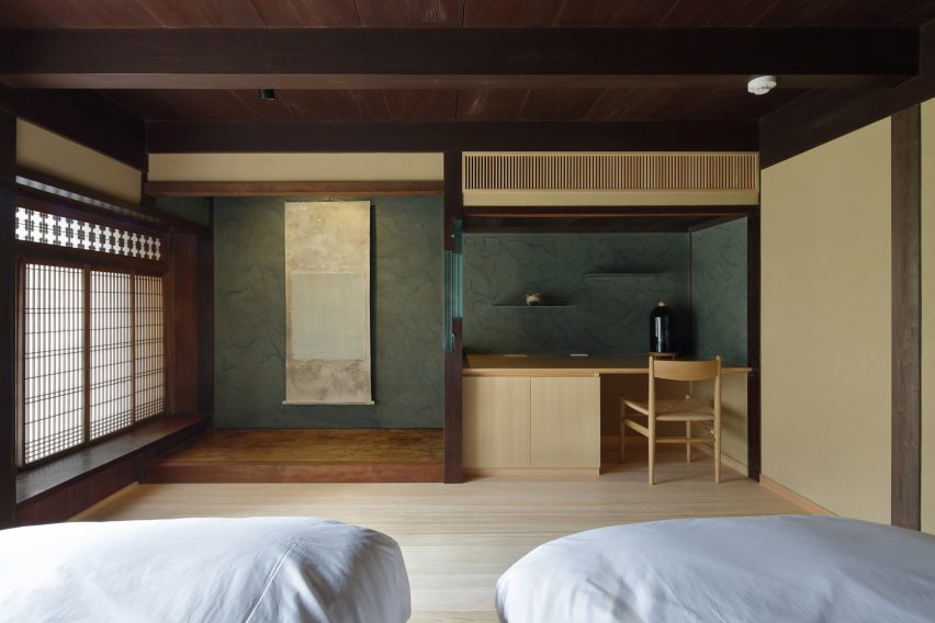 Interior view of a guest room at Hishiya restaurant and guesthouse with green walls