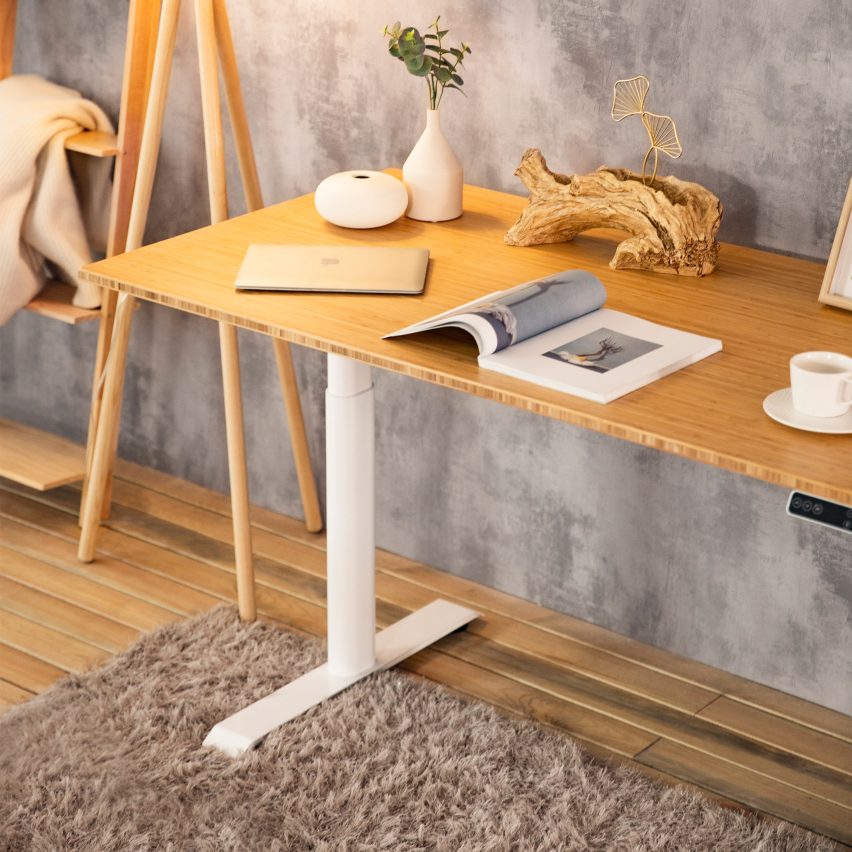A photograph of the Kana Pro Bamboo Standing Desk in a home environment