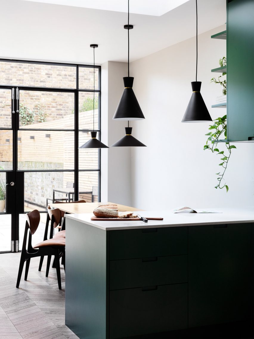Kitchen with dark green cabinets