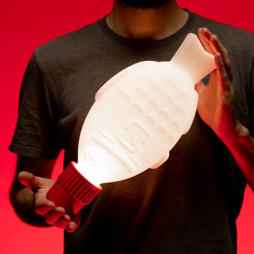 A photograph of Light Soy lighting by Heliograf, which looks like a fish-shaped soy sauce packet
