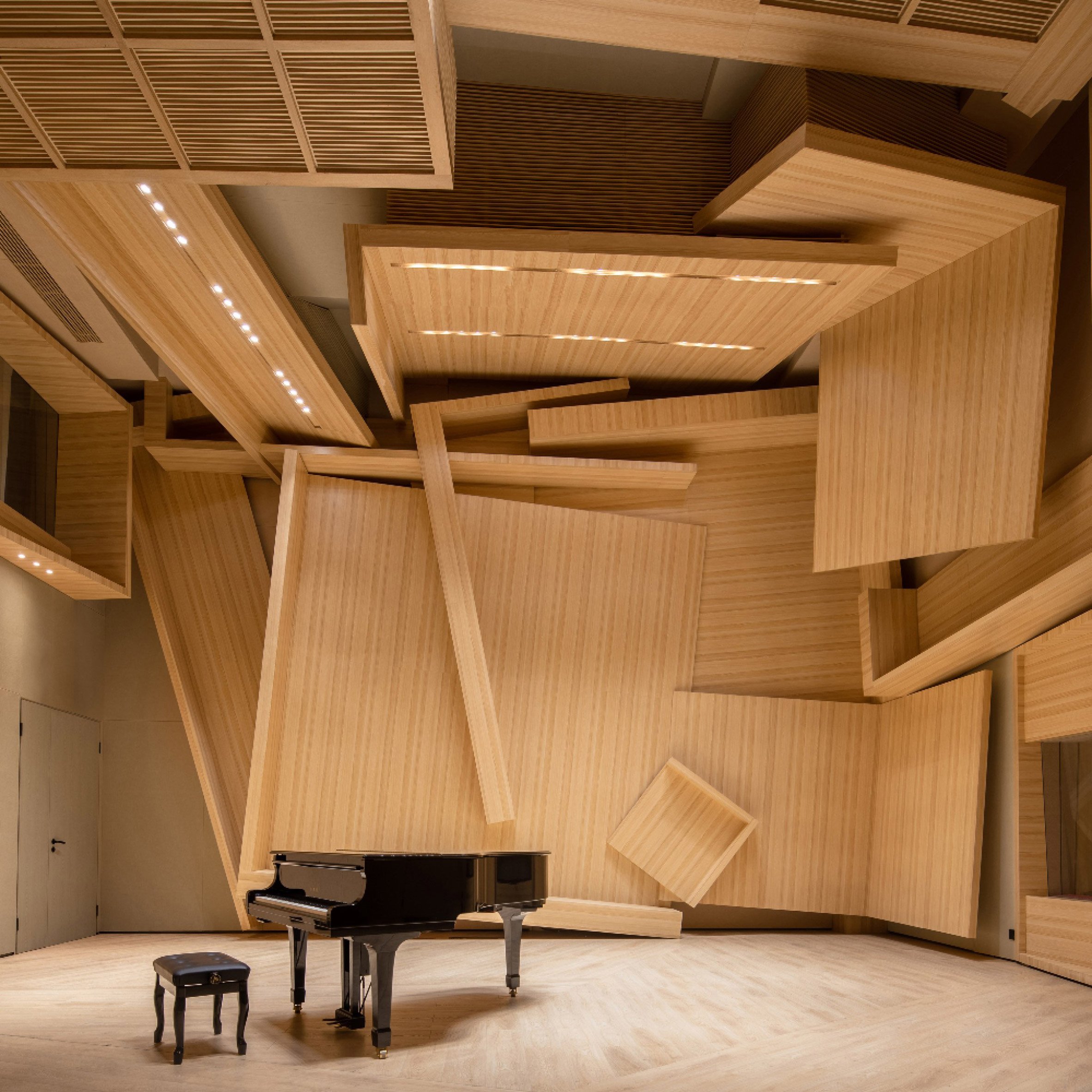 A black piano inside a wooden music studio