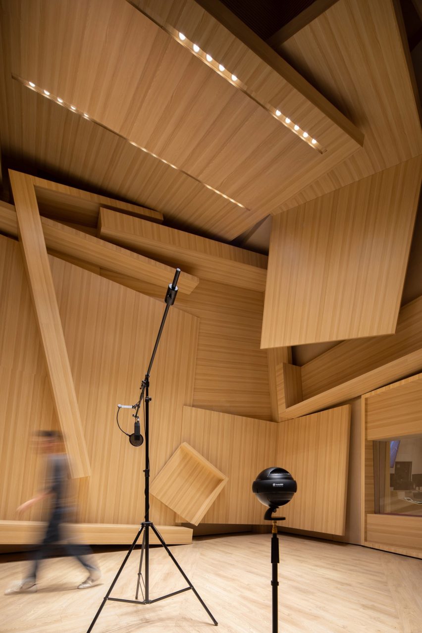 A black microphone inside a wooden music studio