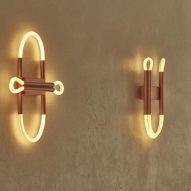 Copper and tube lighting fixtures in sculptural shapes on a wall