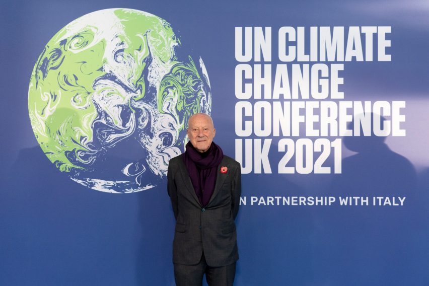 Norman Foster in front of a COP26 poster
