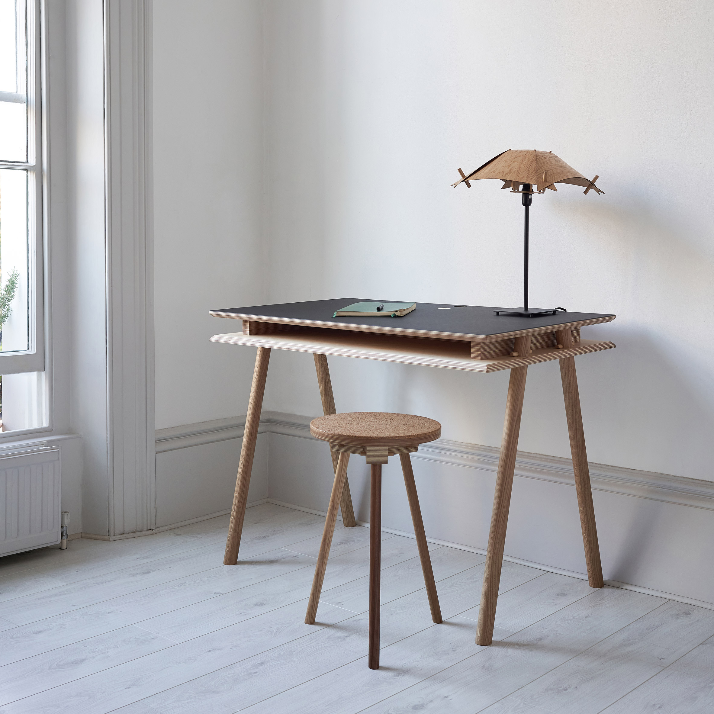 A desk, lamp and stool in the Pegg Furniture range