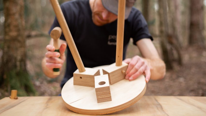 A man constructing a wooden stool