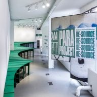 The interior of Re-source exhibition at Storefront for Art and Architecture gallery with row of bright green tables by Lanza Atelier