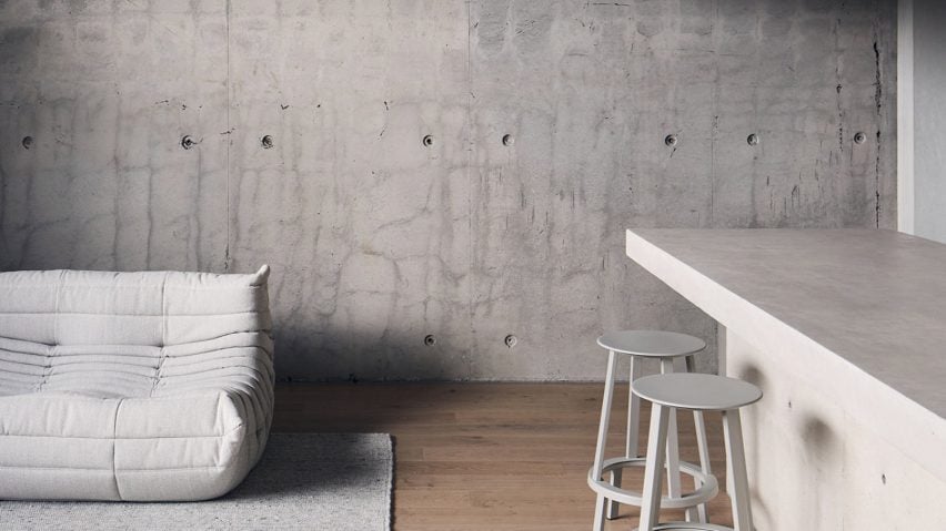 White Togo sofa in front of concrete wall in Roseneath Street apartment by Studio Goss