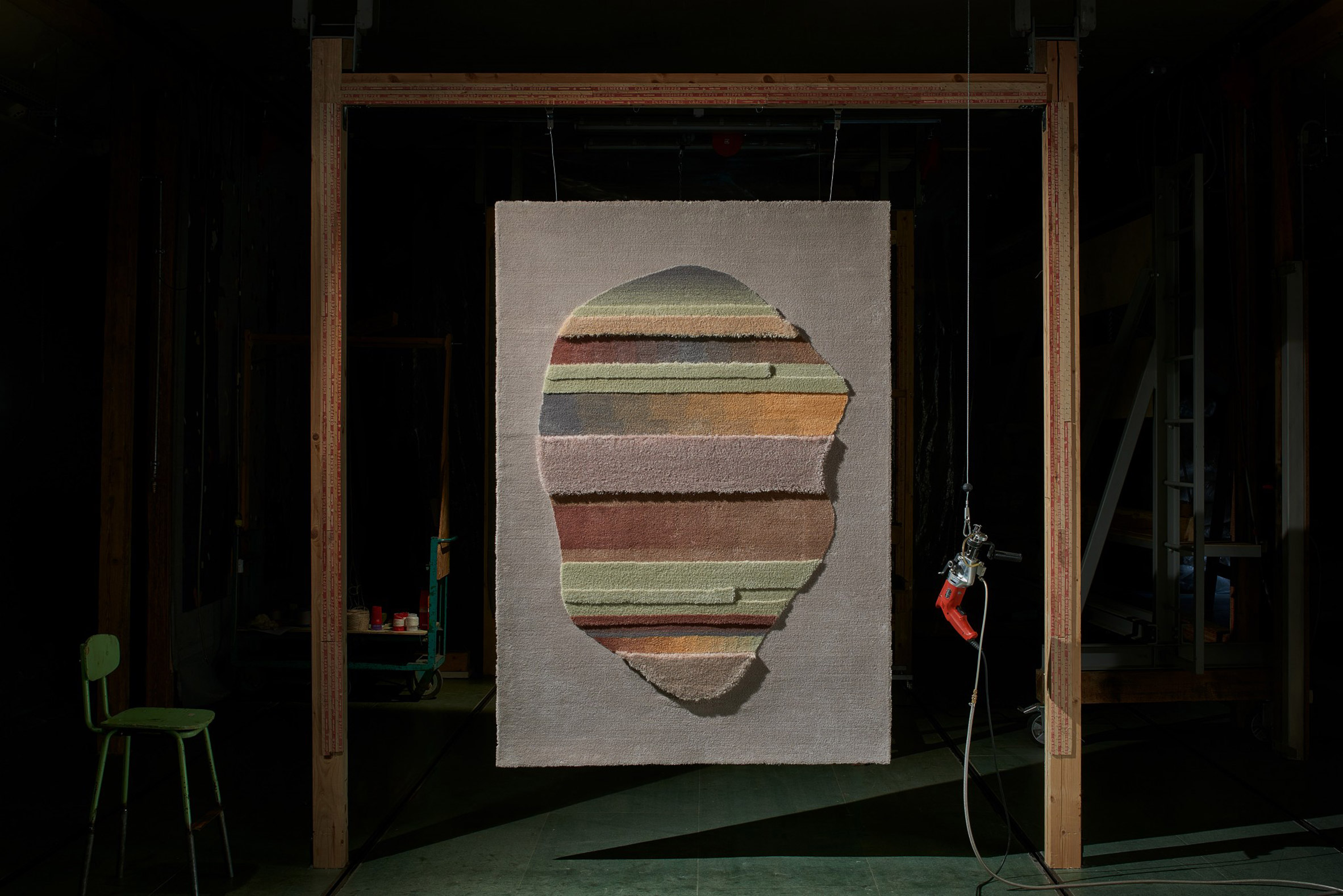 A rug from the Lutetia and Juno collection was hung from a wooden frame