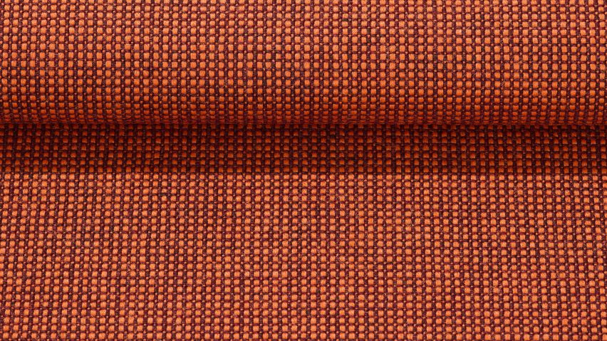 Close up of Kvadrat's Sabi textile upholstery in a deep orange colour